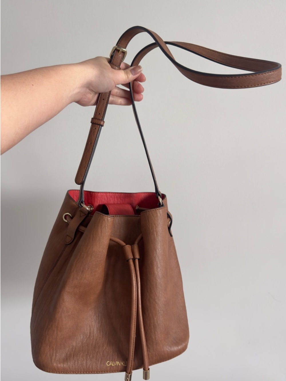 Calvin Klein Tan Leather Drawstring Bucket Bag with Red Lining